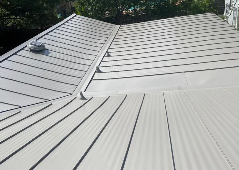 Solar attic fan installed on a metal roof for Roof Ventilation in Demopolis